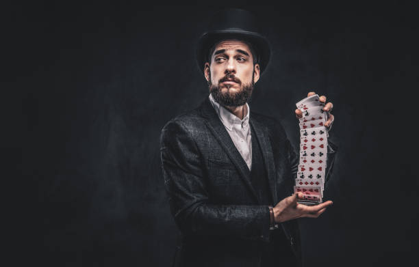 istock Magician showing trick with playing cards. 1182684224