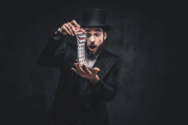 istock Magician showing trick with playing cards. 1182684246