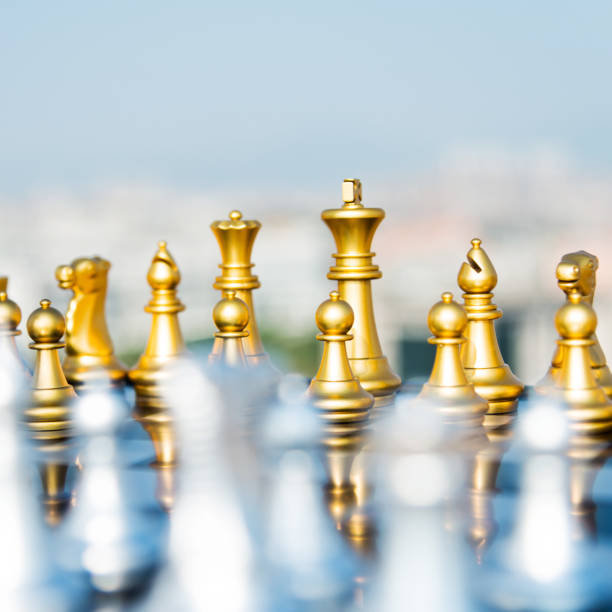 istock Golden and silver chess pieces are on the board 1182684306