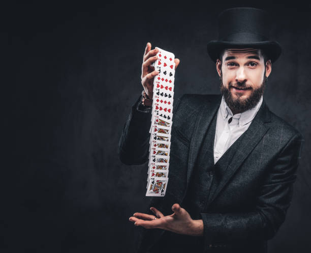 istock Magician showing trick with playing cards. 1182684326