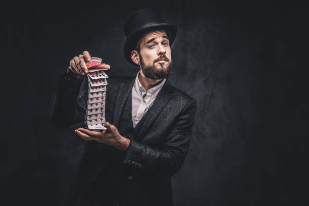 istock Magician showing trick with playing cards. 1182684381