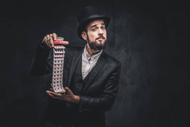 Magician showing trick with playing cards.