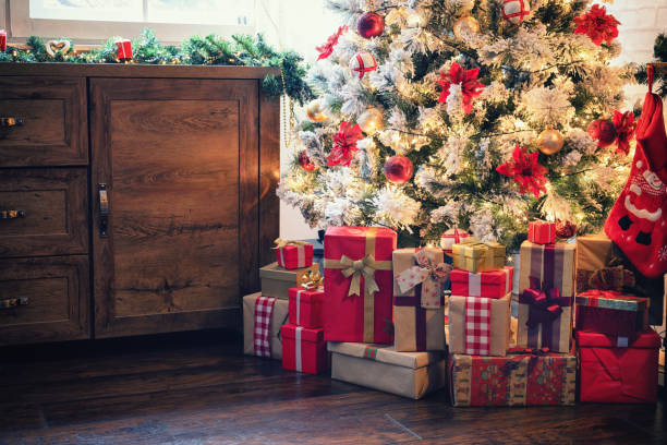 istock Decorated Christmas tree with presents at home 1182686643