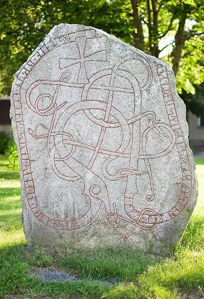 The Kummelby rune stone made in the Viking age and found in 1953 by a farmer in his cropland. The stone now stands outside the Kummelby church in the north of Stockholm, Sweden about 45 meters from the place it was found. The rune text says "This stone was raised by Helga in memory of her husband Sv