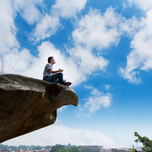 istock Meditation at the edge of a cliff 1182687766