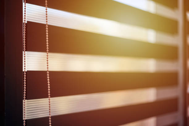 Office blinds. Sunlight through modern fabric blinds. Office meeting room lighting range control.