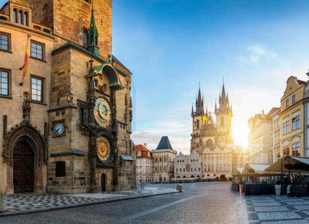 View to the astronomical clock and the old town square of Prague during sunrise View to the astronomical clock and the old town square of Prague with Tyn Church in the background during sunrise time without people. Czech Republic prague stock pictures, royalty-free photos & images