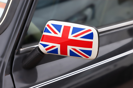 British Patriotism Consept. Side Mirror of a Vintage Car with the UK Flag on It extreme closeup