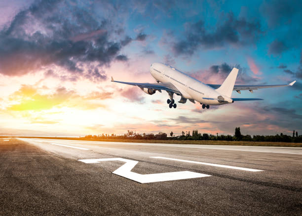 passenger airplane landing at sunset - airplane taking off sky commercial airplane imagens e fotografias de stock