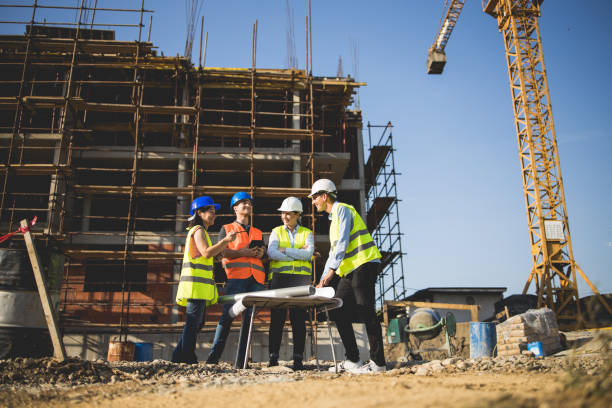 istock Group of construction workers on building site.Stock photo 1182692140