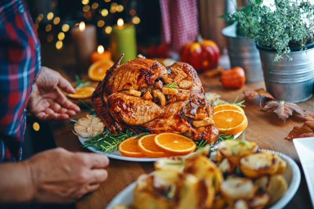 istock Preparing Stuffed Turkey for Holidays in Domestic Kitchen 1182692387