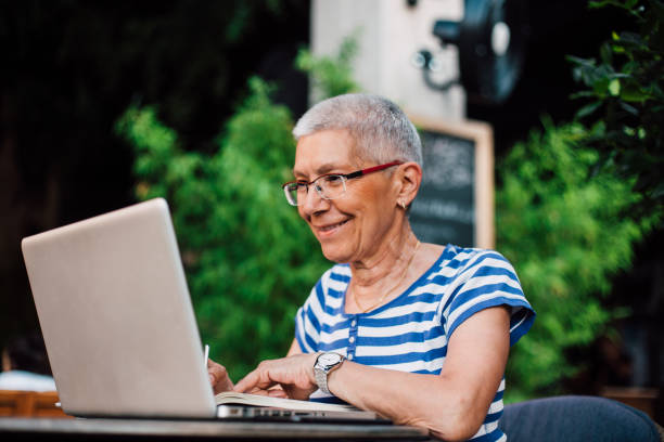 istock Senior woman working from cafe 1182693393
