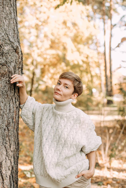 istock autumn yellow leaf fall conceptual girl park 1182693510
