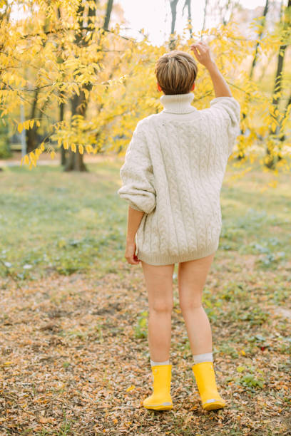 istock autumn yellow leaf fall conceptual girl park 1182693529