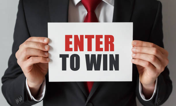 Businessman holding a card with text Enter to Win