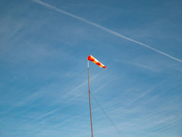 Wind direction indicator on the airfield. Wind direction indicator on the airfield. Navigation. Blue sky. bellows stock pictures, royalty-free photos & images