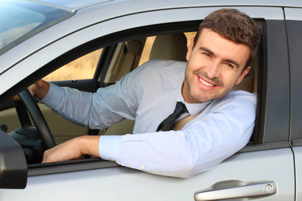 istock Attractive businessman driving a car 1182697010