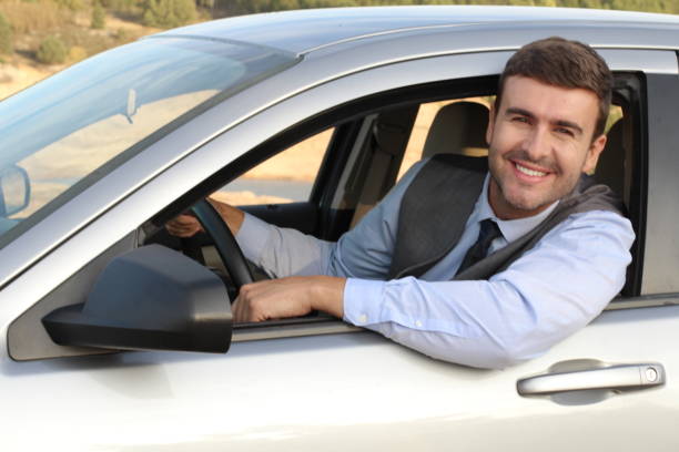 istock Attractive businessman driving a car 1182697033