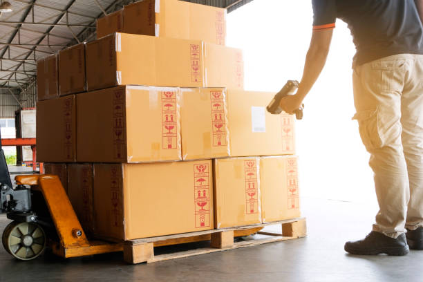 Worker scanning barcode scanner on package boxes on pallet Worker scanning barcode scanner on package boxes on pallet, warehouse industry delivery to transport bkk stock pictures, royalty-free photos & images