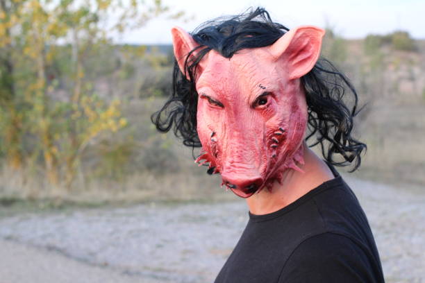 istock Really scary person wearing a pig mask 1182697187
