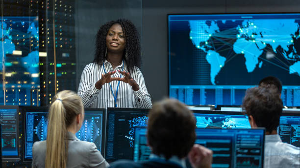 istock Chief Project Engineer Holds Briefing for a Team of Scientists that are Building Machine Learning System. Displays Show Working Model of Neural Network. 1182697757