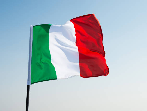 istock Italian flag waving in the sky 1182697826