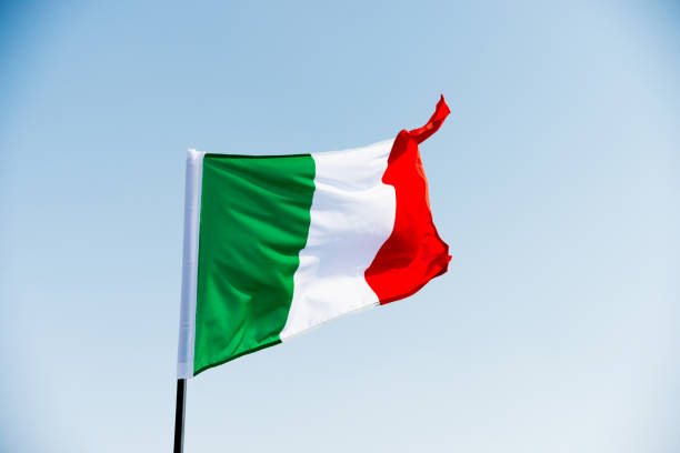 istock Italian flag waving in the sky 1182698780