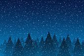 istock Snowfall - Tranquil Christmas scene with falling snow and fir trees 1182701157