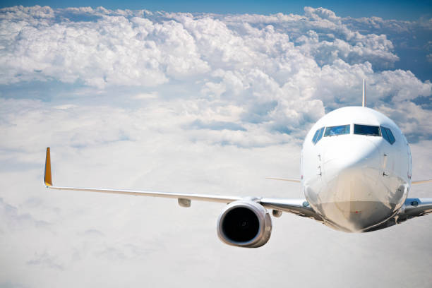 istock Commercial airplane flying over clouds. 1182701558