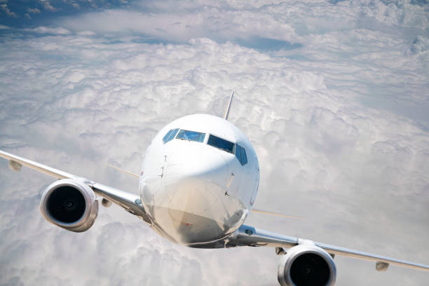 istock Commercial airplane flying over clouds. 1182701898