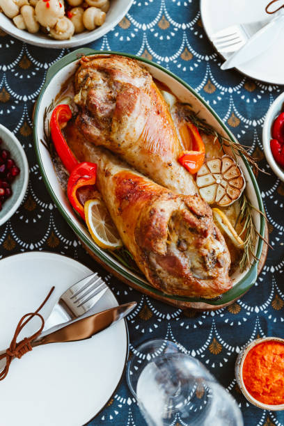 istock Festive dish for Thanksgiving, roasted turkey legs with vegetables on a table with appetizers. Top view, flat lay. 1182701948