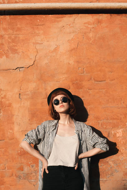 istock Young woman posing near the wall 1182701989