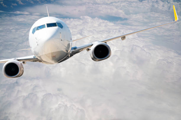 istock Commercial airplane flying over clouds. 1182702123