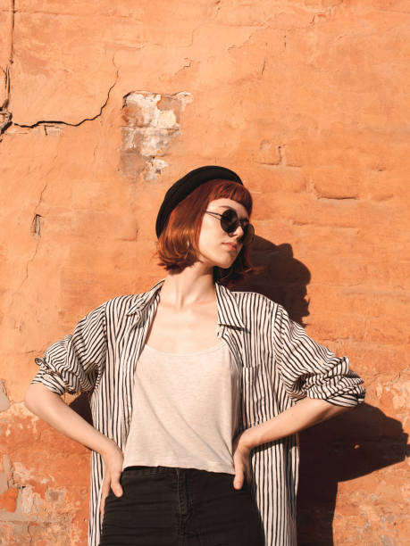 istock Young woman posing near the wall 1182702980