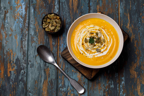 istock Vegetarian autumn pumpkin cream soup with seeds 1182703459