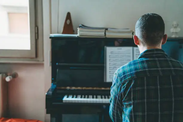 Young adult singer pianist exercising at home