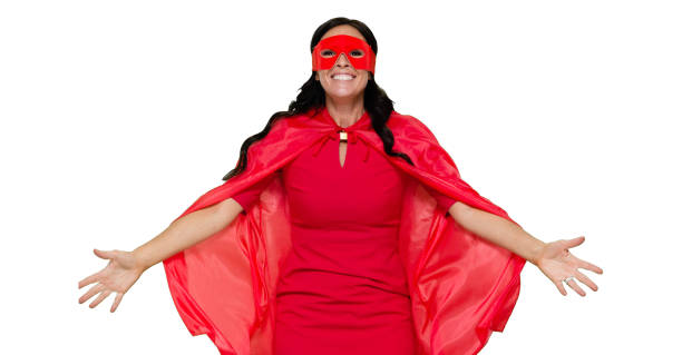 front view / one person / waist up / portrait of adult beautiful black hair caucasian female / young women superhero / heroines / hero standing wearing dress / eye mask / mask - disguise / costume / cape - garment / cool attitude and celebration - thank you excitement waist up horizontal imagens e fotografias de stock