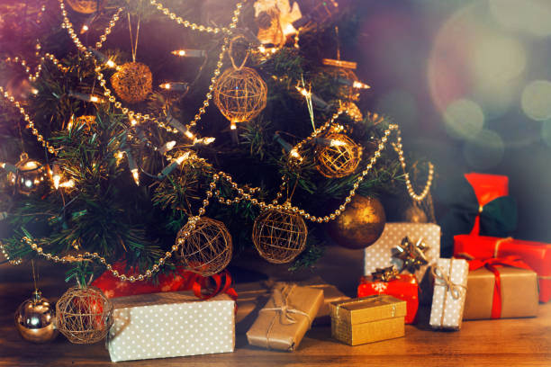 istock Christmas gifts next to a christmas tree 1182704080