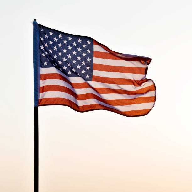 istock American flag waving in sunset 1182705381