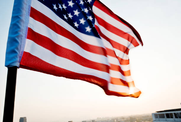 istock American flag waving in sunset 1182705684