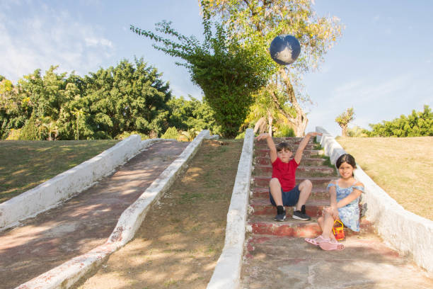 istock kids playing in the park 1182706253