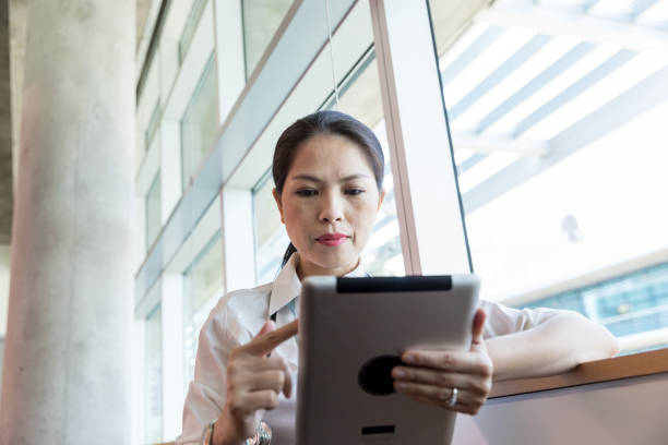 istock Low angle view doctor reviewing patient charts on tablet 1182706346