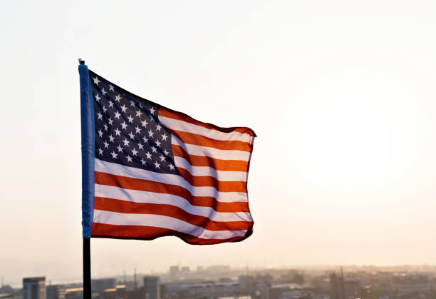istock American flag waving in sunset 1182706673