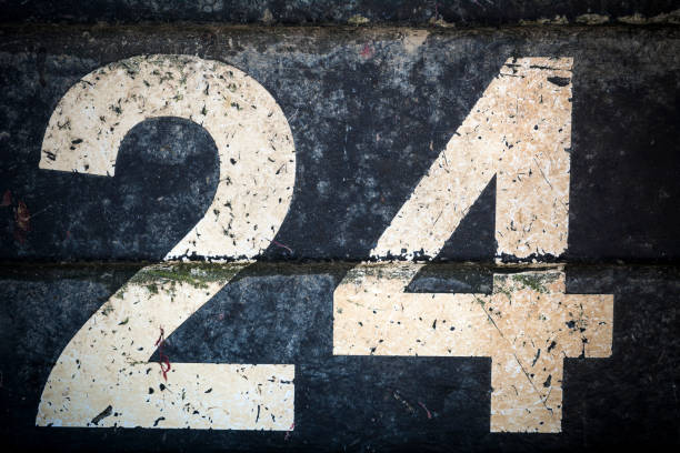 istock Weathered number twenty four in bold figures on black background 1182706720