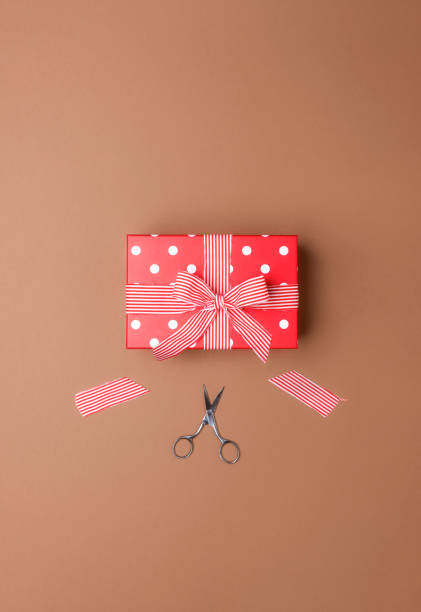 istock Gift wrapping with a red gift box and ribbon cutting. Presents 1182706966
