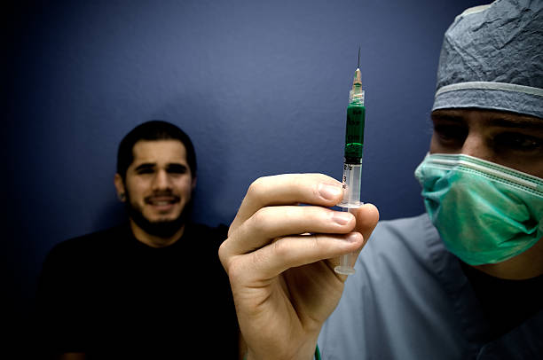 若い医者 - injecting syringe spooky male ストックフォトと画像