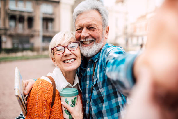 istock Senior couple on vacation taking a selfie 1182709438