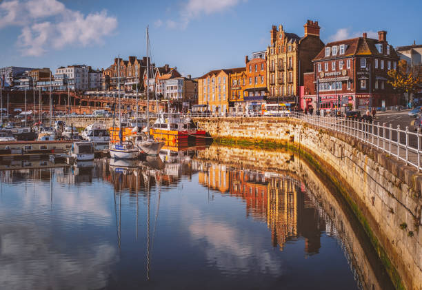Ramsgate, Royal Harbour, Kent, UK RAMSGATE, ENGLAND - OCT 22 2019 The bright colourful buildings, cafes and restaurants along the quayside of the impressive historic Royal Harbour thanet photos stock pictures, royalty-free photos & images