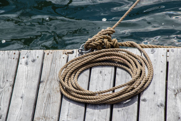 istock rope coiled on a wooden dock securing a vessel 1182713032