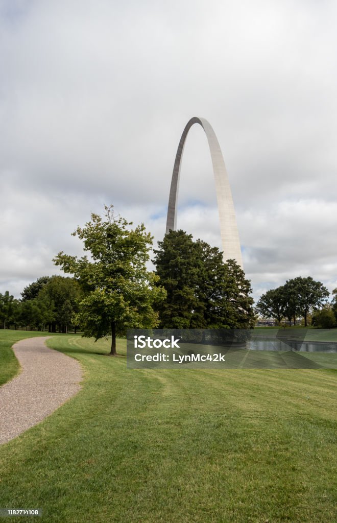 pathway to the The Arch at Gateway Arch National Park, St. Louis, Missouri pathway to the Gateway Arch on a cloudy day Arch - Architectural Feature Stock Photo